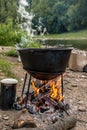 A cauldron for cooking is on the fire Royalty Free Stock Photo