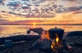 Weekend on the river. Dawn by the water. Cooking over a campfire Royalty Free Stock Photo