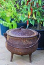 A Cauldron, three-legged pot, for cooking food slowly over an open fire.