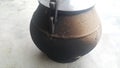 Cauldron type rural pressure cooker covered with mud