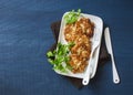 Cauliflower and chicken fritters on a blue background, top view. Delicious appetizer