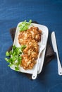 Cauliflower and chicken fritters on a blue background, top view. Delicious appetizer