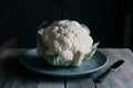 Cauliflower displayed on kitchen table, versatile vegetable captured beautifully