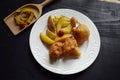 Cauliflower fried in batter on wooden black background and potatoes.Healthy food