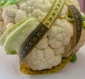 Cauliflower with measuring tape on a white background Royalty Free Stock Photo