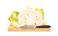 Cauliflower and nutmeg and grater on a chopping board Royalty Free Stock Photo