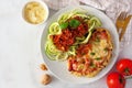 Healthy plant-based cauliflower parmesan and zucchini pasta topped with meatless walnut cauliflower bolognese, above view scene on Royalty Free Stock Photo