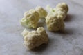 Cauliflower pieces closeup in white background.