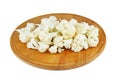 Cauliflower pieces on wooden cutting board isolated on white