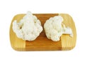 Cauliflower pieces on wooden cutting board isolated