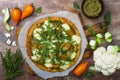 Cauliflower pizza crust with pesto, yellow tomatoes, zucchini, mozzarella cheese and squash blossom Royalty Free Stock Photo