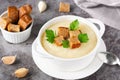 Cauliflower potato soup puree on stone background, Creamy cauliflower soup with toasted bread croutons. Royalty Free Stock Photo