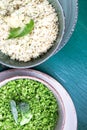 Cauliflower rice and broccoli rice in bowl on green background. Top view. Overhead. Copy space. Shredded. Royalty Free Stock Photo