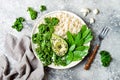 Cauliflower rice Buddha bowl with kale, avocado, seeds, snow peas and tahini dressing.