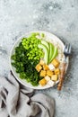 Cauliflower rice Buddha bowl with massaged kale, tofu, avocado and edamame beans. Vegan poke bowl.