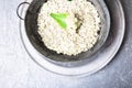 Cauliflower rice in metal bowl on grey background. Top view. Overhead. Copy space. Shredded Royalty Free Stock Photo