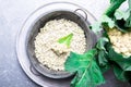 Cauliflower rice in metal bowl on grey background. Top view. Overhead. Copy space. Shredded Royalty Free Stock Photo