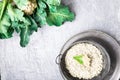 Cauliflower rice in metal bowl on grey background. Top view. Overhead. Copy space. Shredded Royalty Free Stock Photo