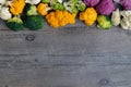 Cauliflower and romanesco broccoli on wooden background. Healthy food concept Royalty Free Stock Photo