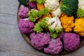 Cauliflower and romanesco broccoli on wooden background. Healthy food concept Royalty Free Stock Photo