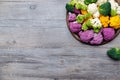 Cauliflower and romanesco broccoli on wooden background. Healthy food concept Royalty Free Stock Photo