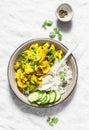 Cauliflower, squash, zucchini, turmeric, yogurt stir fry with rice on a light background, top view. Vegetarian diet healthy food