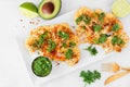 Cauliflower steaks top view scene over white marble, healthy plant based meat substitute concept