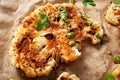 cauliflower steaks with herb and spice on baking tray. plant based meat substitute