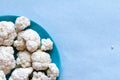 Cauliflowers isolated on blue background, very healthy vegetarian food with micronutrients