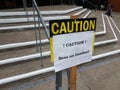 caution bees on handrail sign on steps