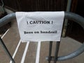 caution bees on handrail sign on steps