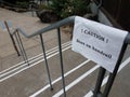 caution bees on handrail sign on steps