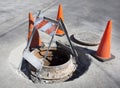Caution cones marking sewer drainage repair site. Royalty Free Stock Photo