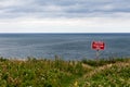 Caution Dangerous Cliffs Sign Over Ocean