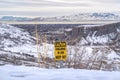 Caution Firearms In Use Keep Out sign on a mountain covered with snow in winter