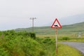 Caution otters crossing road sign in a green landscape in Scotland Royalty Free Stock Photo