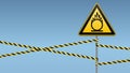 Caution oxidizer. Safety sign. Safety at work. Yellow triangle with black image, metal pillar, protective tapes. Sky