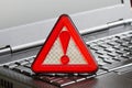 Caution sign on black laptop computer virus detected alert hacking piracy Royalty Free Stock Photo