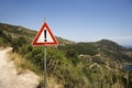 Caution sign on coastal dirt road. Royalty Free Stock Photo