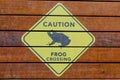 Caution sign, frogs crossing, in a zoo