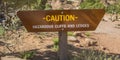 Caution sign on risky mountain at sunny day