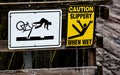 2 caution signs on a wooden rail