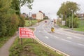 Caution site entrance lorries turning warning road sign on British road daylight view Royalty Free Stock Photo