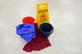 Caution slippery floor sign beside buckets and towels on a wet floor Royalty Free Stock Photo