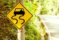 Caution of slippery roads - traffic signs beside country road Royalty Free Stock Photo