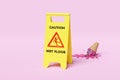 Caution slippery or wet floor caution plastic sign with ice cream cones fallen on the floor isolated on blue background. warning