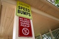 Caution Speed Bumps No Cell Phones During Pickup Sign