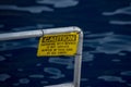 Caution swiimming with sharks yellow sign Royalty Free Stock Photo