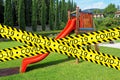 Caution tape closing children`s playground due to COVID-19 or Coronavirus security protection measures