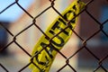 Caution tape tied to a chain-link fence outside of an elementary school in Winnipeg, Manitoba Royalty Free Stock Photo